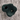 En grøn klatresten lavet i plast fra Nordic Play som hænger i en væg 